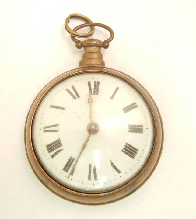 Key wind pocket watch, open face brass case, Roman: Key wind pocket watch, open face brass case, Roman Numeral dial, convex crystal, 2" diameter, outer brass case has label that reads "Daniel Monnier Clock and Watch Maker, Philadelphia"