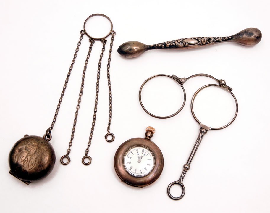 Sterling silver lot including glove darner with re: Sterling silver lot including glove darner with repousse floral motif, 4 1/4" long, marked Sterling, chatelaine ring with coin holder and three additional chains on finger ring, marked Sterling, coin 