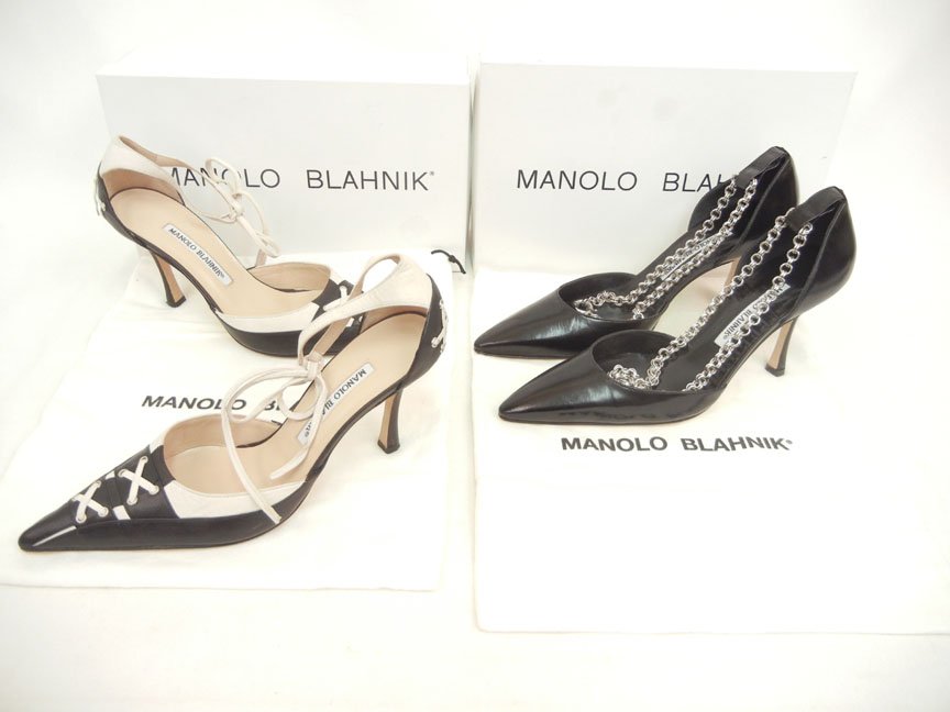Two pair of Manolo Blahnik black leather shoes, on: Two pair of Manolo Blahnik black leather shoes, one pair "Coopla", size 37 1/2, 3" heels, silver tone chain ankle straps, unused condition, original box and dust cover, and one "Martitakhi", size 37 1