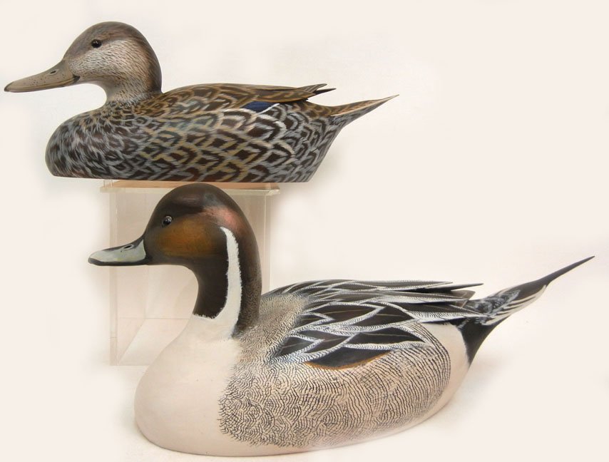 Two duck decoys by John Wood, one "Drake Pintail": Two duck decoys by John Wood, one "Drake Pintail" 6 3/4" high x 16 1/8" across, and a "Hen Pintail", 6" high x 15 1/4" across, artist signed and titled on bottoms