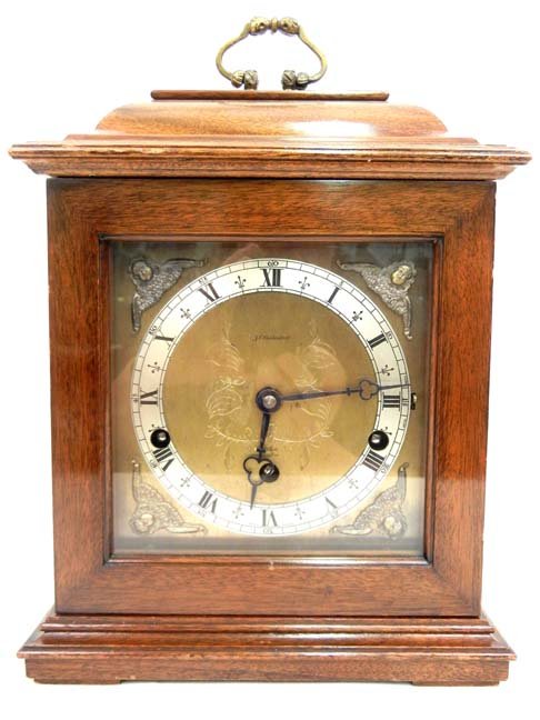 F.W. Elliott mantle clock, mahogany cased, marked : F.W. Elliott mantle clock, mahogany cased, marked J.E. Caldwell, Elliott London, Made in England, applied figural decorations on spandrels, 7 jewels, two chimes - Westminster and Whittington, 12" x 8 