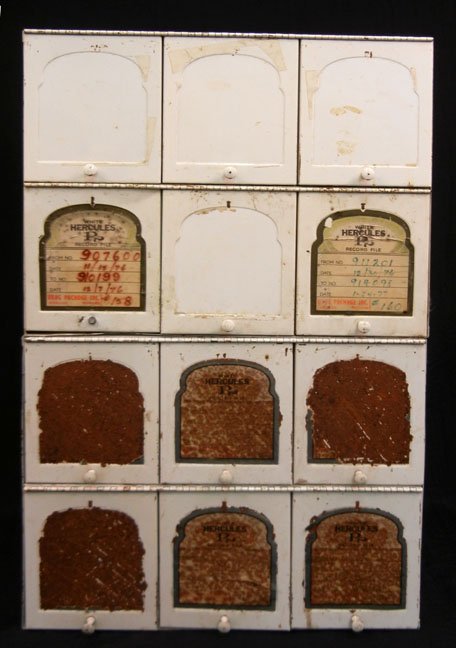 Two piece stacking metal apothecary cabinets, each: Two piece stacking metal apothecary cabinets, each with six hinged doors, "White Hercules Record File" on door fronts, early 20th C., 24" high x 15 1/2" x 9 3/4"