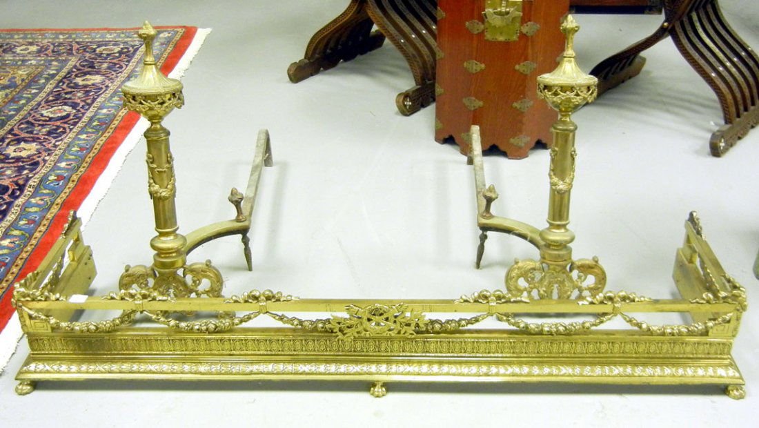 Louis XV style three piece brass fireplace set,: Louis XV style three piece brass fireplace set, including pair of andirons 22 1/2" high x 26 1/2" across, and fender with paw feet 7 3/4" high x 49" across