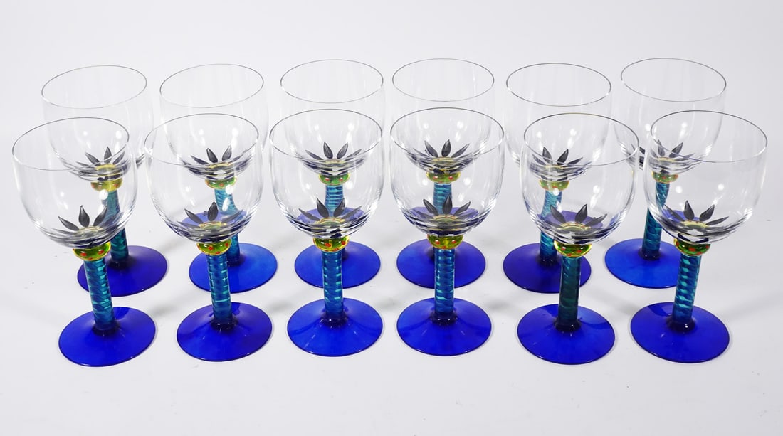 Kosta Boda Swedish Art Glass Wine Glasses: Set of twelve Kosta Boda Swedish art glass Palm Trees pattern wine glasses, designed by Ken Done, each glass is signed on underside of base Kosta Boda Ken Done, circa contemporary 20th c., 6 1/2" (h)