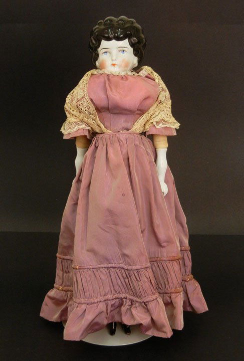 Large vintage china head doll, painted blue eyes an: Large vintage china head doll, painted blue eyes and closed mouth, molded and painted hair, cloth body, china arms and legs with molded and painted boots, marked on back "736, 7 Germany", 20"