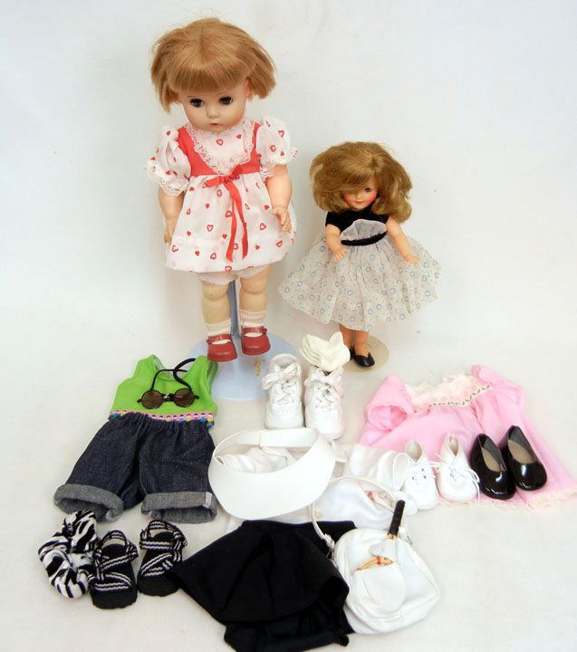 Two vinyl dolls, Ideal Shirley Temple, 12", in orig: Two vinyl dolls, Ideal Shirley Temple, 12", in original outfit, green sleep eyes, painted and applied lashes, open mouth with teeth, marked on back of head, ca. 1960, and a 15 1/2" doll, green sleep e
