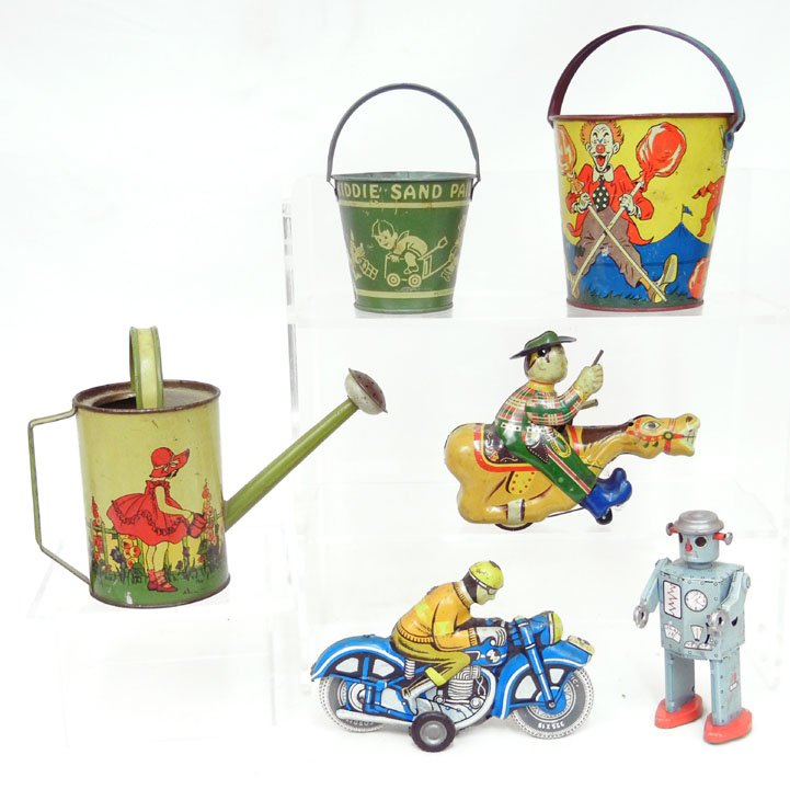 Grouping of tin litho toys, including motorcycle w: Grouping of tin litho toys, including motorcycle with rider, tin friction car marked with a "L", wind up Alps Japan cowboy on horse, wind up robot, Heideberger Confectionery Co. Phila, PA sand pail, M