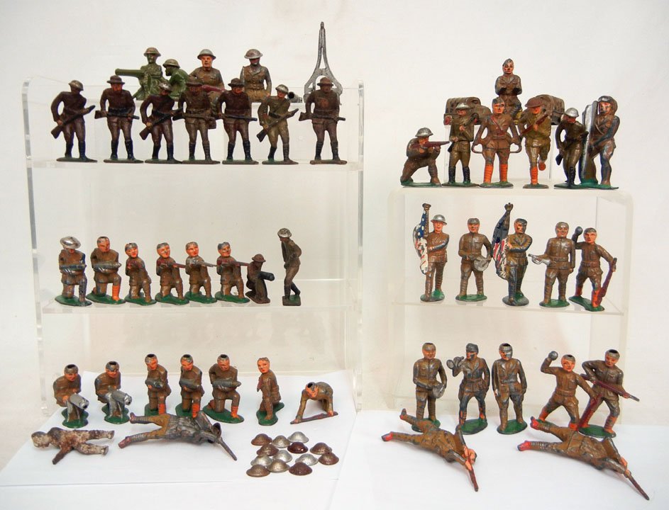 Fifty-one diecast soldiers, including two army tru: Fifty-one diecast soldiers, including two army trucks, and a cannon stand, some are Barclay