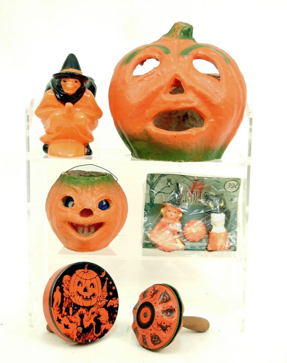 Grouping of vintage Halloween collectibles,: including two paper mache Jack-o-lantern candle holders, two lithographed tin noisemakers, three piece Halloween candle set in original wrapping, and a hard plastic withc riding broom candy container,
