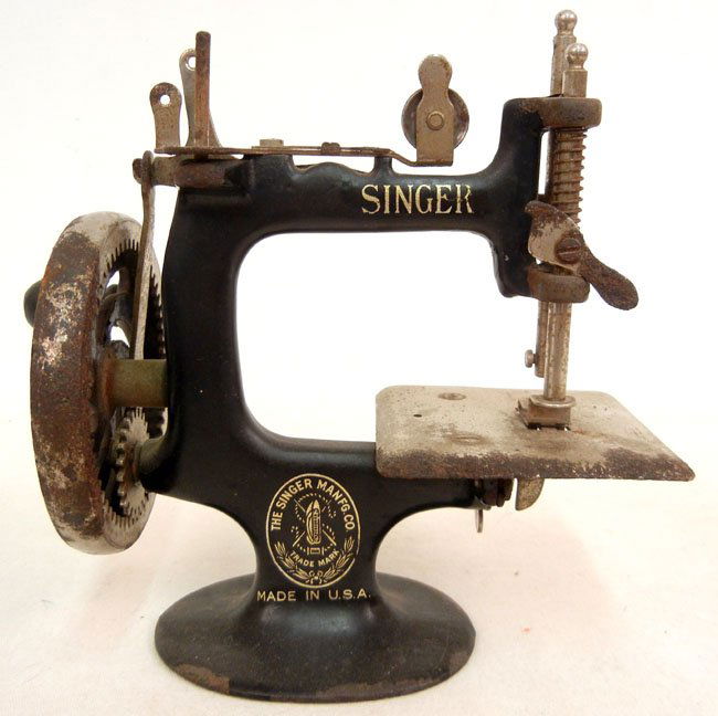 Singer child's sewing machine, hand crank,: Singer child's sewing machine, hand crank, by Singer Manufacturing Co., 7" high x 7" across