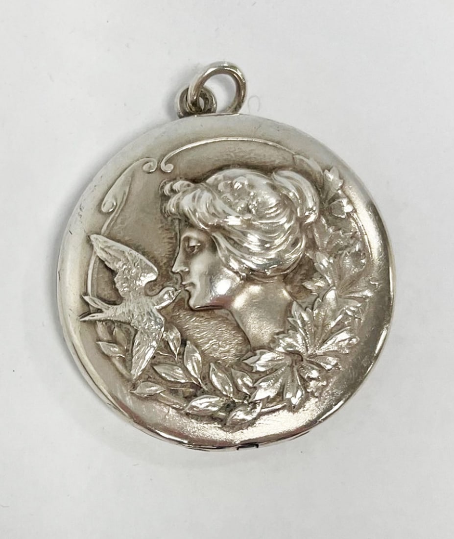 Sterling Silver Art Nouveau Locket: Sterling silver Art Nouveau round locket, repouss? profile of woman and bird, monogrammed on back, stamped Sterling inside, 35mm diameter, 12.1 grams