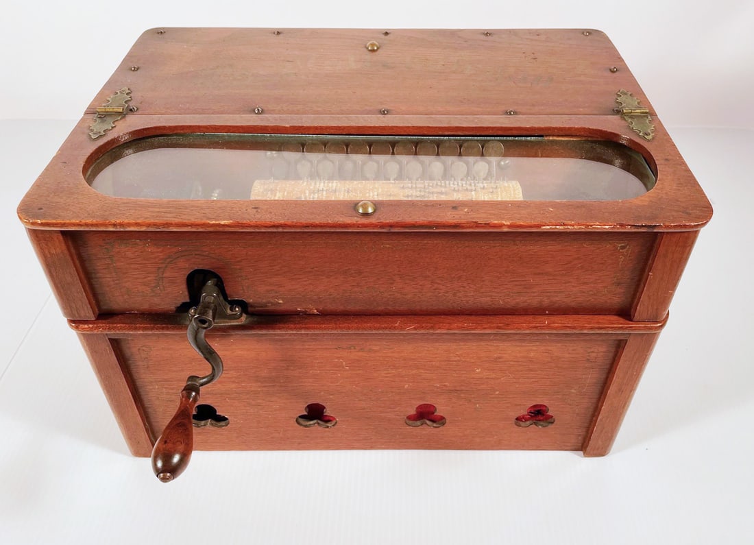 Antique Concert The Roller Organ: Antique concert The Roller Organ, walnut cased w/shamrock shaped speaker openings on front, side and back panels, crank turn handle, stenciled designs, plays corn cob rolls, original operating instruc