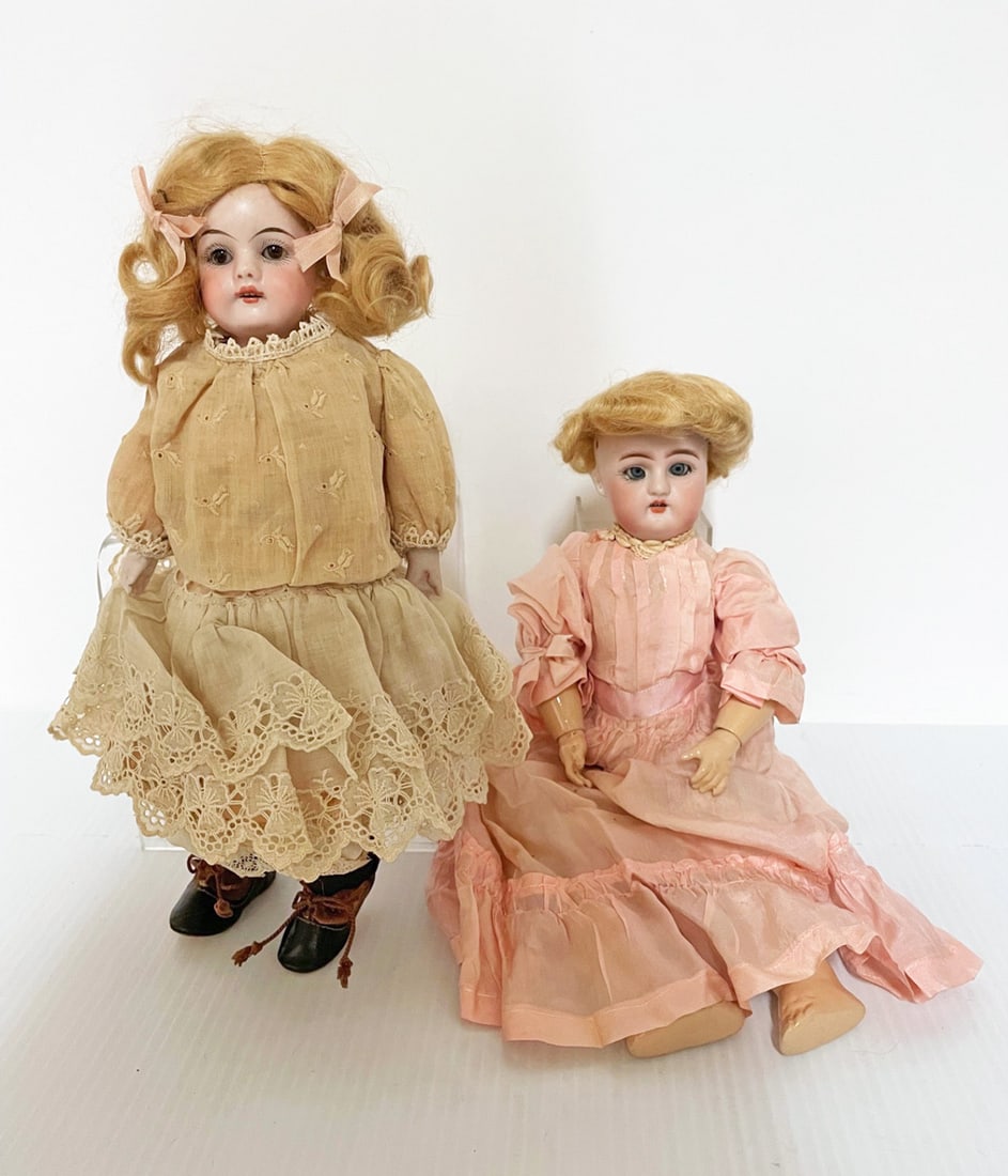 Two German bisque head dolls: Two German bisque head dolls, Heinrich Handwerck 12" doll with pierced ears, open mouth and teeth, body appears to be repainted, and bisque shoulder head doll marked Germany with brown sleep eyes, kid