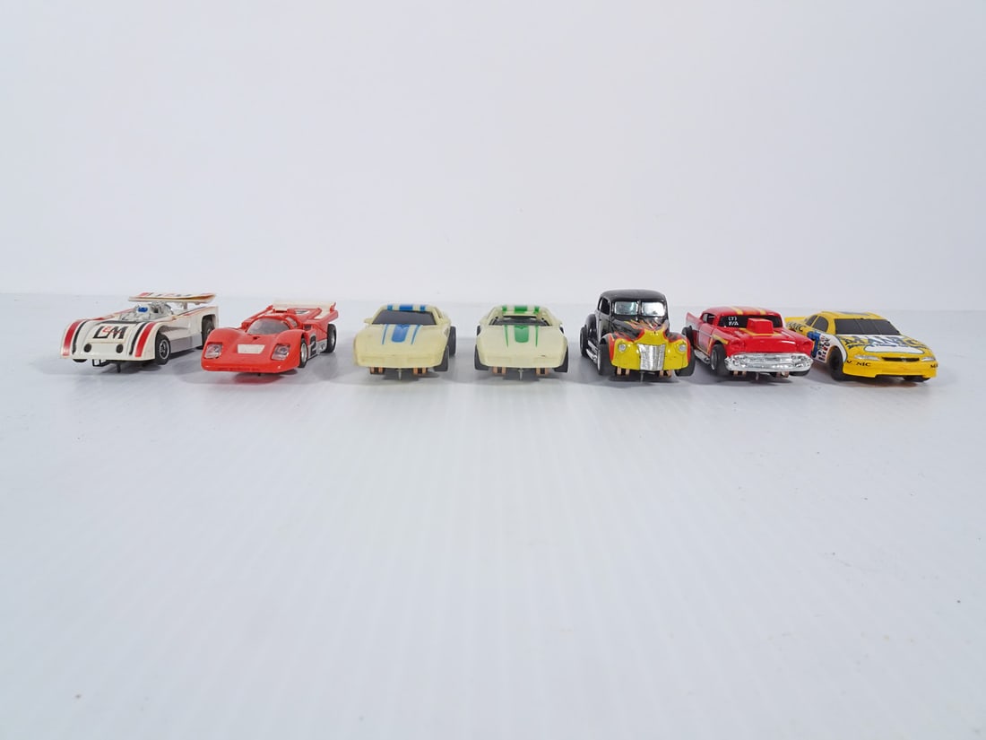 Vintage AFX and Tyco Slot Cars Grouping: Seven piece vintage AFX and Tyco slot cars grouping, AFX Lola T-60 Can-Am, Manic Chevy Monte Carlo Stocker and Red Ferrari 512 M #2 and Tyco '40 Ford Coupe Black, Nite Glow Corvette w/blue stripe, Nit