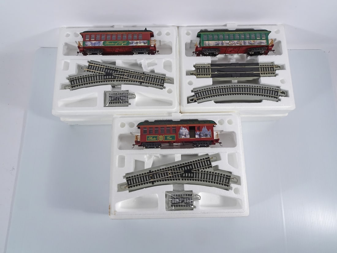 Hawthorne Village Thomas Kinkade Christmas Trains: Three piece Bachmann Industries Inc. Hawthorne Village Thomas Kinkade Christmas Express modern era HO scale trains grouping, Painter of Light parlor car, Thomas Kinkade's studio car and Victorian Chri