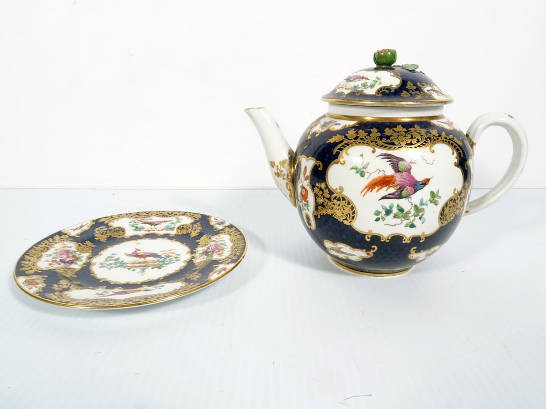 Worcester English Porcelain Teapot with Underplate: Worcester English porcelain teapot with underplate, cobalt blue over white glaze with hand painted gilt overlay, pheasant bird and floral designs, teapot lid with applied floral mount finial, both pie