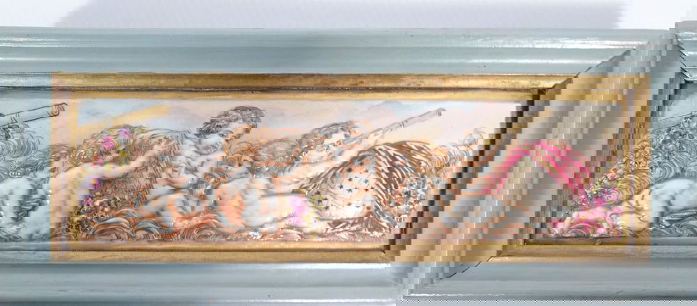 Capodimonte Italian Porcelain Framed Panel: Capodimonte Italian porcelain framed panel, decorated with hand painted fully figural relief molded putti and floral designs, marked on verso with blue underglaze crown and N mark, circa late 19th c.