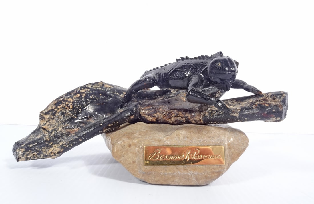 Bernard K. Passman Black Coral Sculpture: Bernard K. Passman (Cayman Islands artist, 1916-2007) black coral sculpture, titled Basking in the Sun-Iguana, mounted on a carved stone base, limited edition #6/100, attached brass plaque with Bernar