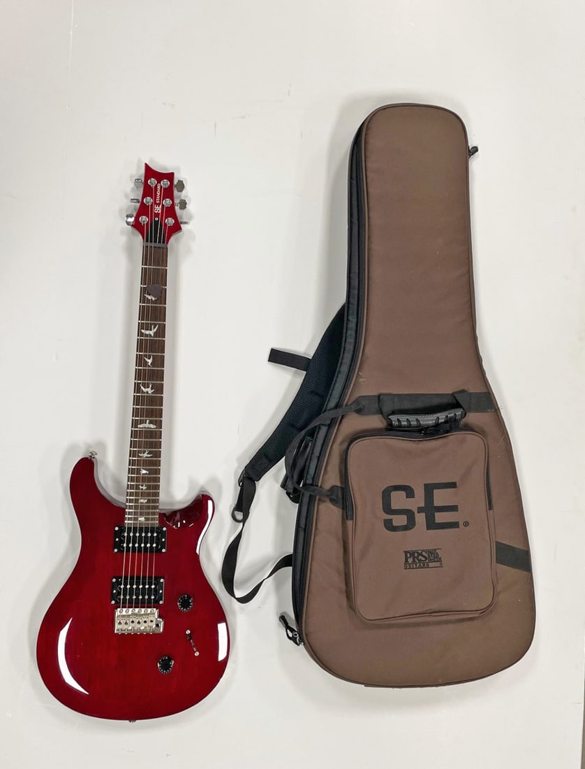 Paul Reed Smith SE Standard Electric Guitar: Paul Reed Smith SE CE 24 Standard model six string electric guitar, mahogany solid body, wine red finish, serial #IC00324, comes with a factory padded gig bag, circa 21st c.,38 5/8" (h) x 12 7/8" x 1