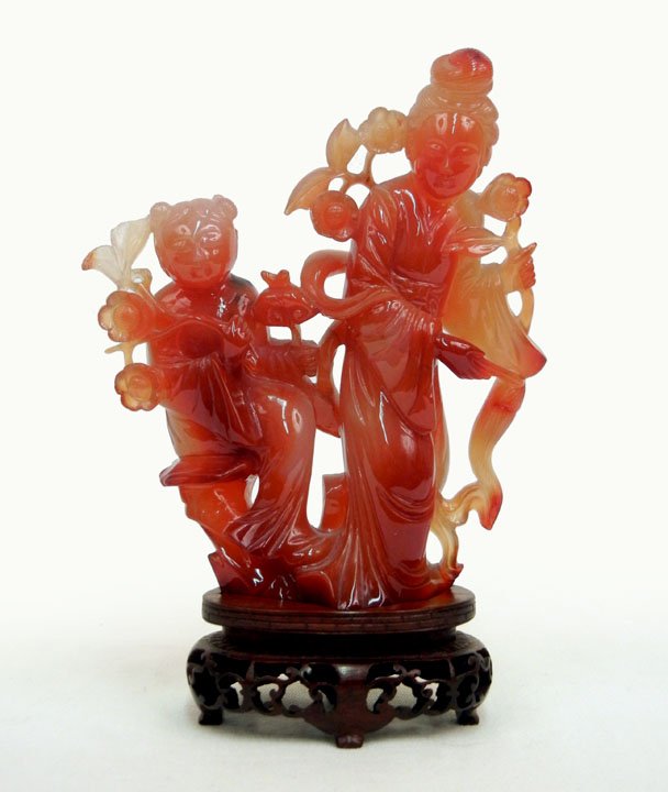 Carnelian carving of Kivannon and attendant, Japan: Carnelian carving of Kivannon and attendant, Japan late 19th C., on fitted wooden base, 5 1/8" high, ex. Collection of Theodore Roosevelt Hanff, with the appraisal from 1981.