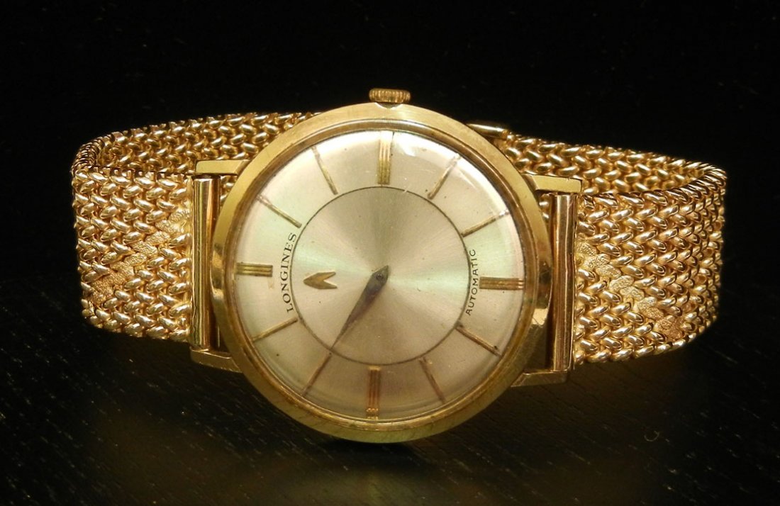 Man's 14K gold Longines automatic wristwatch, case: Man's 14K gold Longines automatic wristwatch, case measures 1 1/4" in diameter, band is 6 7/8" long x 5/8" wide, case and band are marked 14K, weight 60.2 grams/38.6 dwt (complete), mid 20th C.