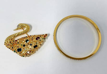 Swarovski Brooch and Bangle: Swarovski brooch and bangle, multi-colored jeweled swan brooch 2" x 2 1/2", Swarovski stamp on back, and bangle with row of crystals 2 3/4" diameter, both in Swarovski felt bags