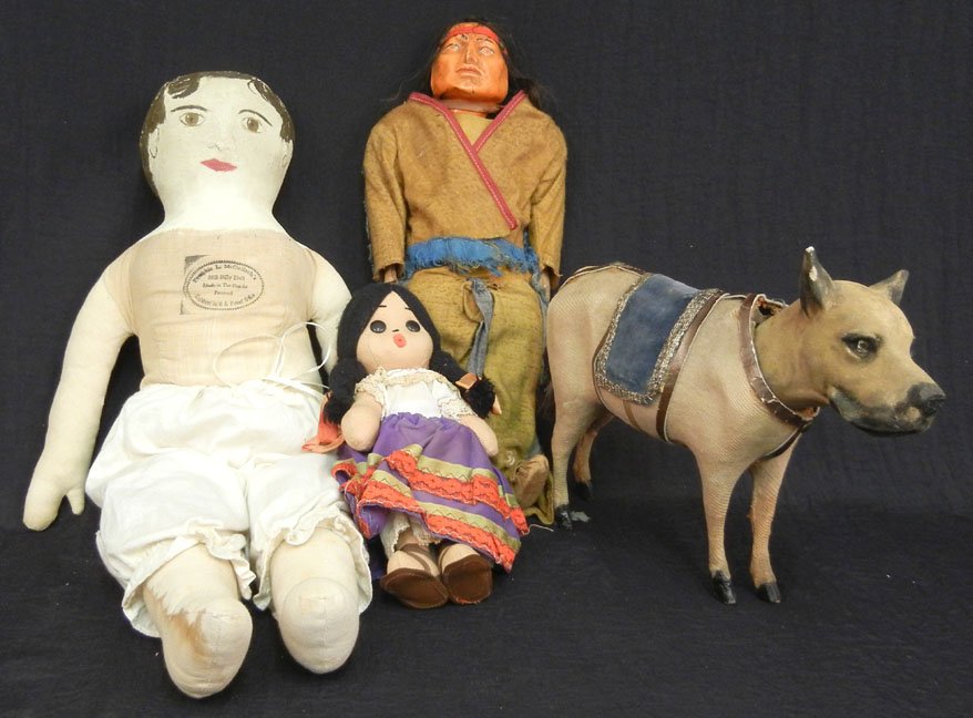 Grouping of early cloth dolls including Skookum Indian : Grouping of early cloth dolls including Skookum Indian doll with celluloid face, Frankie L. McCulloch's Hill-Billy doll, and bottom of a horse candy dispenser with dog head