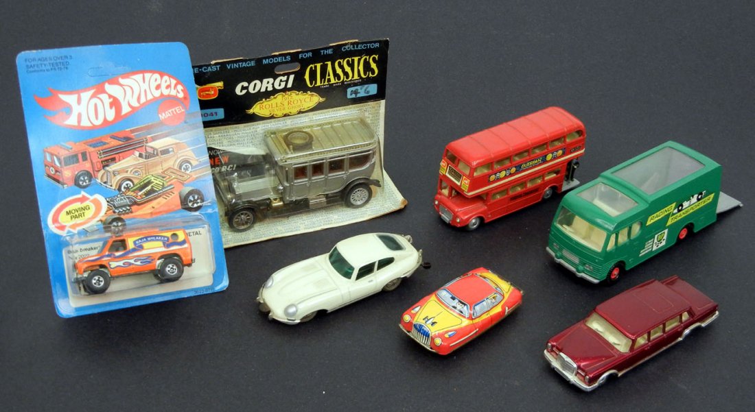 Grouping of toy cars, including Corgi and Hot Wheels, ": Grouping of toy cars, including Corgi and Hot Wheels, "Matchbox" by Lesney racing car transporter, tin litho car, Corgi Mercedes-Benz 600 Pullman, Schuco Micro Racer Jaguar "E" type, Corgi London Tran
