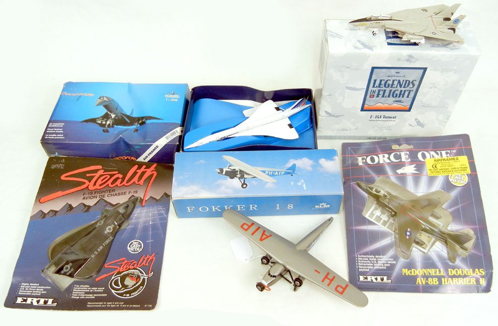 Grouping of boxed aircrafts, including Ertl Force One M: Grouping of boxed aircrafts, including Ertl Force One McDonnell Douglas AV8B Harrier II, Ertl Force One series F-19 Fighter, Schabak AF Concorde, Hallmark Legends F-14A, and a Fokker F-18, largest 10"