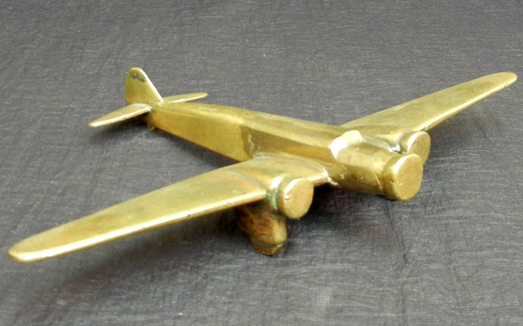 Trench Art Dewoitine Trimotor model, brass, made from b: Trench Art Dewoitine Trimotor model, brass, made from brass bullets and casings and scrap metal in the field during WWII and later by soldiers and mechanics, 9 3/4" wing span, 6 3/4" long