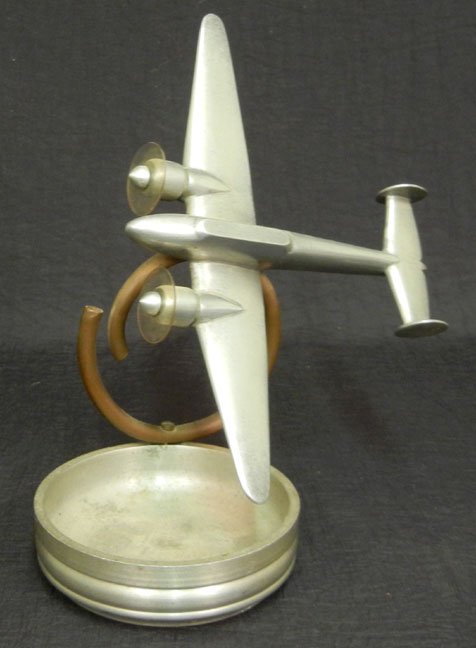 Trench Art Potez ashtray, brass, made from brass bullet: Trench Art Potez ashtray, brass, made from brass bullets and casings and scrap metal in the field during WWII and later by soldiers and mechanics, stand made using fuel line and cylinder, 8" high, 9" 