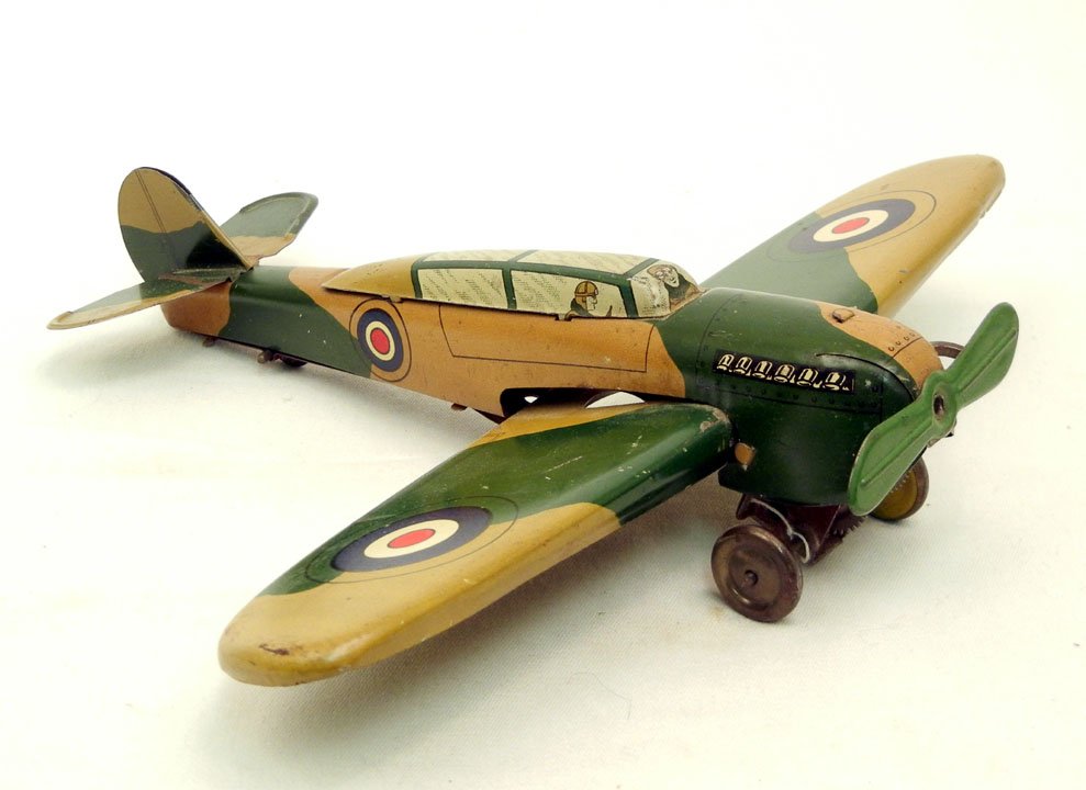 English tin litho wind-up toy of a WWII British fighter: English tin litho wind-up toy of a WWII British fighter, probably made by Wells-Brimtoy Ltd., marked "Made in England" across tail lifts,1940's, 10" wing span, 8 3/4" long