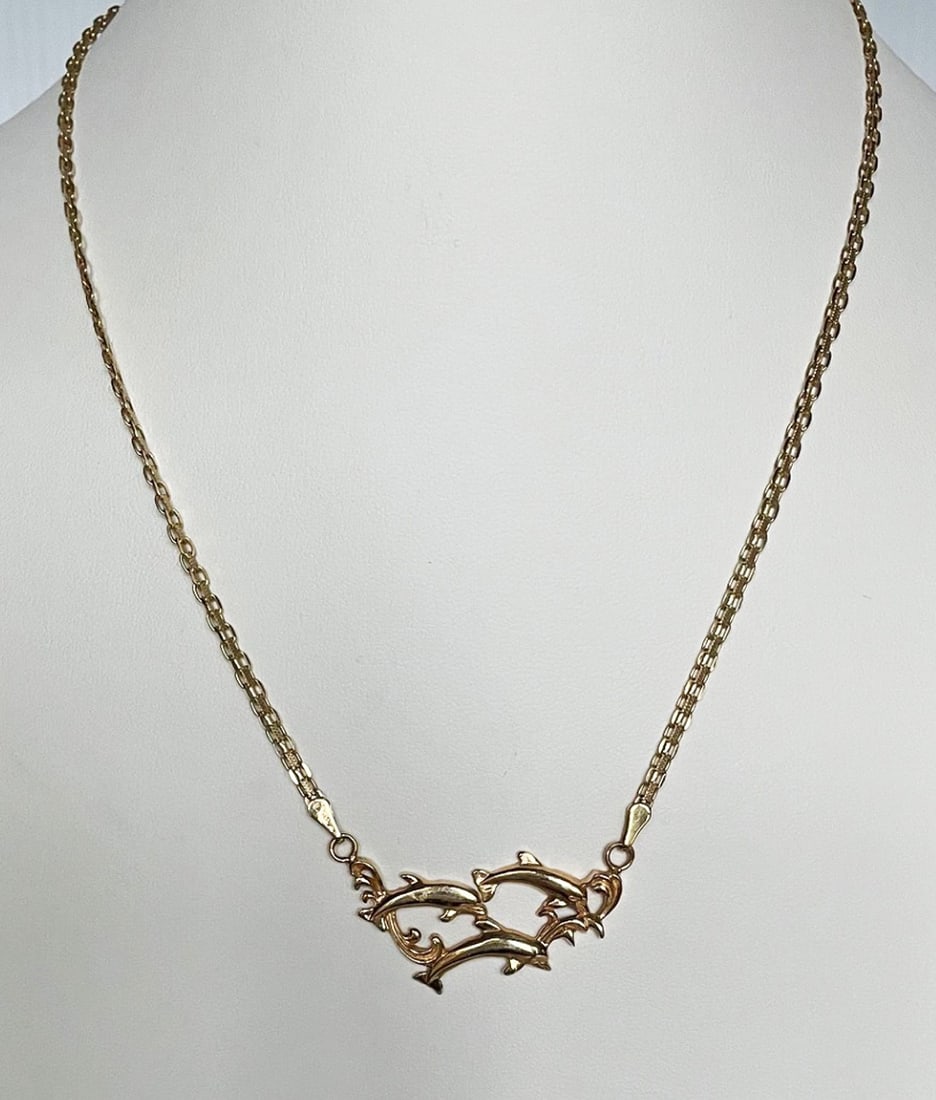 14K Gold Necklace: 14K gold necklace with three dolphins, stamped 14K with maker's stamp, 17 1/2" total length, dolphins 1 1/2" across, 9.4 grams