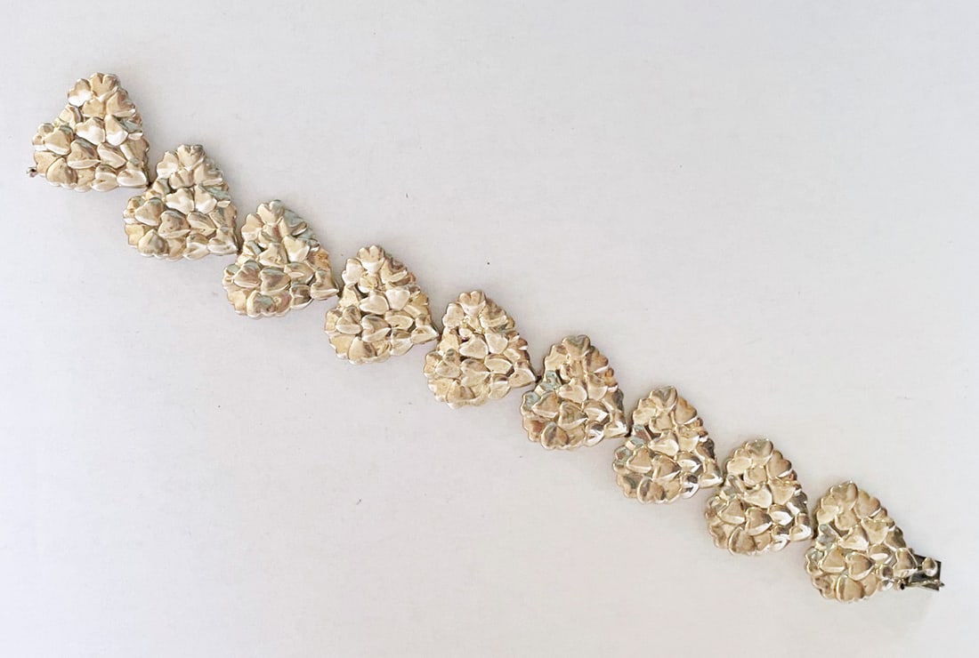 Movado Vintage Sterling Silver Hearts Bracelet: Movado vintage sterling silver hearts bracelet, artist signed (unknown signature) stamped Movado Sterling, 1" wide x 7 1/2", 49.2 grams