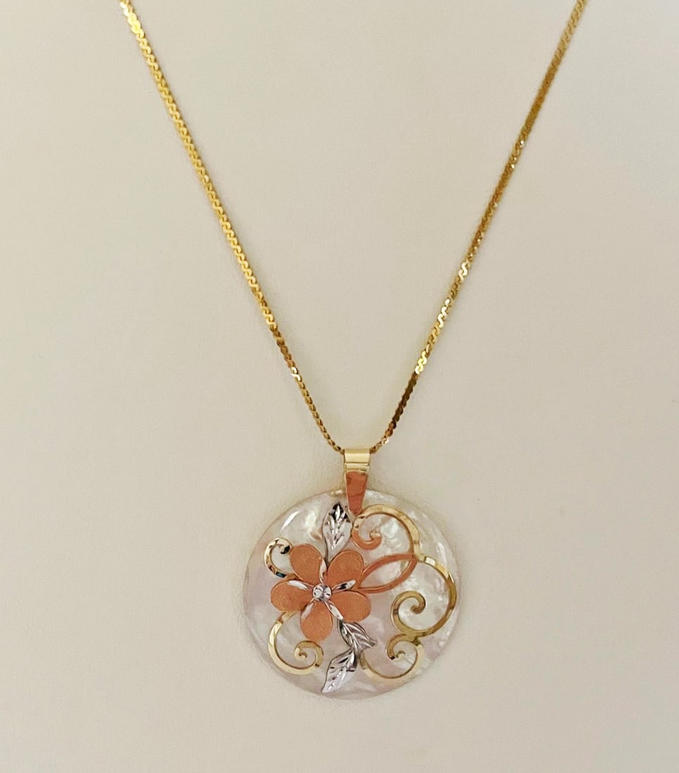 Mother of Pearl 14k Gold Pendant and Chain: Mother of Pearl 14k Gold Pendant and Chain, round pendant with tri-color gold floral overlay, 1 1/4" in diameter, stamped 14k, 20" serpentine link chain, stamped 14k Italy on clasp, weight 7.0 grams c