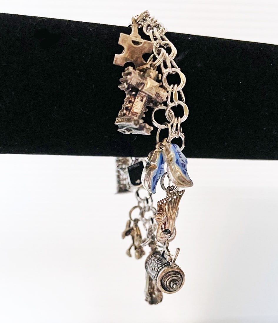 Sterling Silver Travel Charm Bracelet: Sterling silver travel charm bracelet, 7' long bracelet, marked sterling with ten sterling silver charms ranging in size from 1/2" to 1", weight 32.4 grams