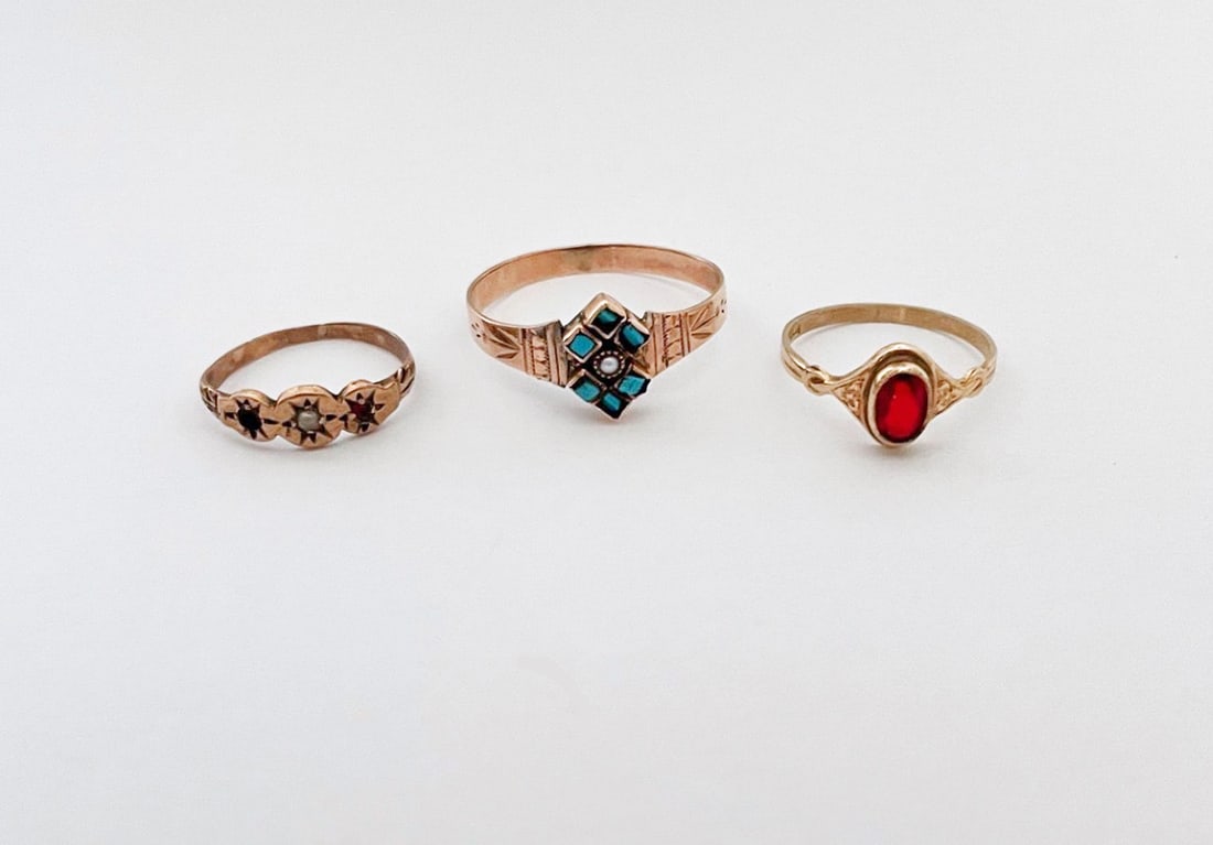 Three Victorian Gold Rings: Three Victorian gold rings, includes two baby rings, one with red stone, size 3 1/2, marked 10k, and one with three small stones (one is missing), size 1 1/2, unmarked; and one 10k with turquoise and