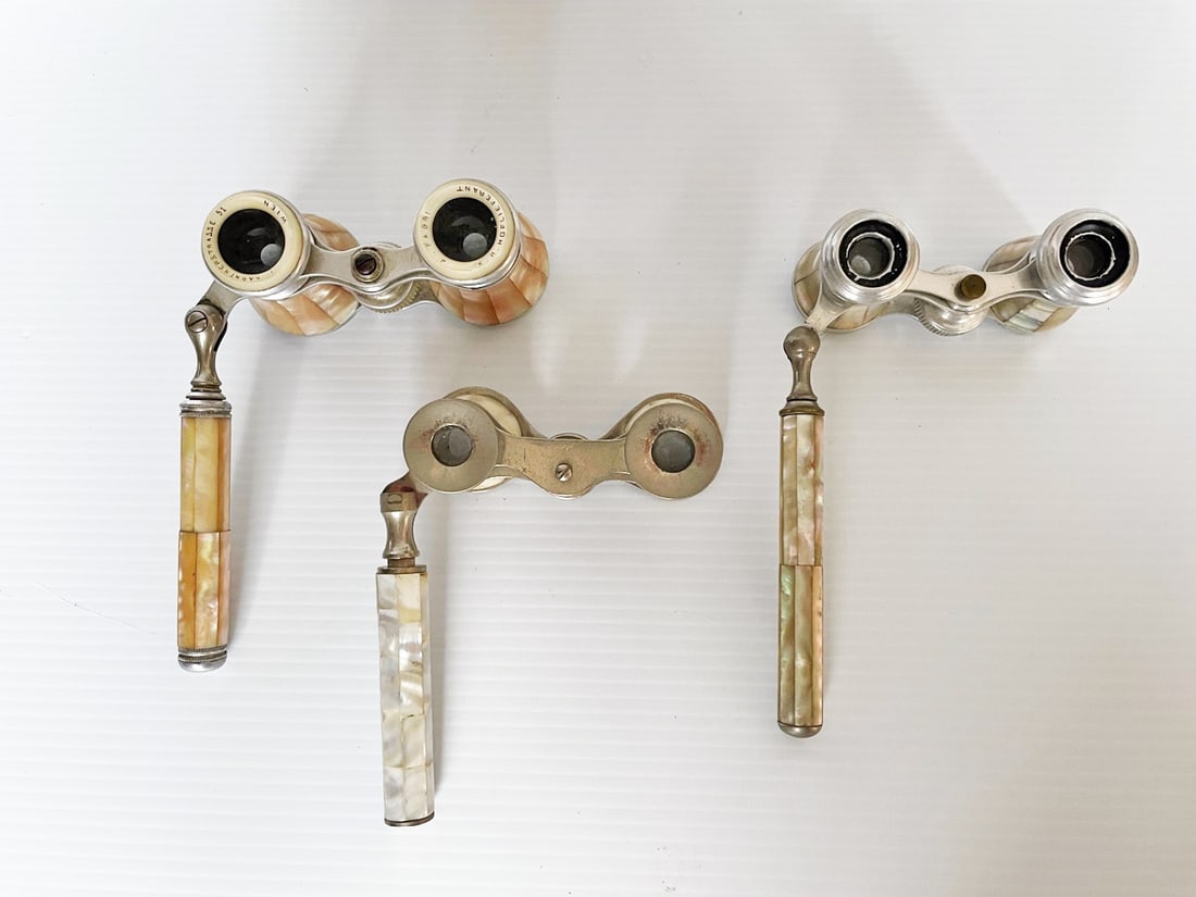 Three Pairs of Opera Glasses with Handles: Three pairs of opera glasses with handles, one golden mother of pearl, 4 1/4" x 2 1/4" with 4 1/2" handle, marked K. A. Hoflieferant J. Fabri, and I. Karntnerstrasse 51 Wien (Austro-Hungarian), one 3