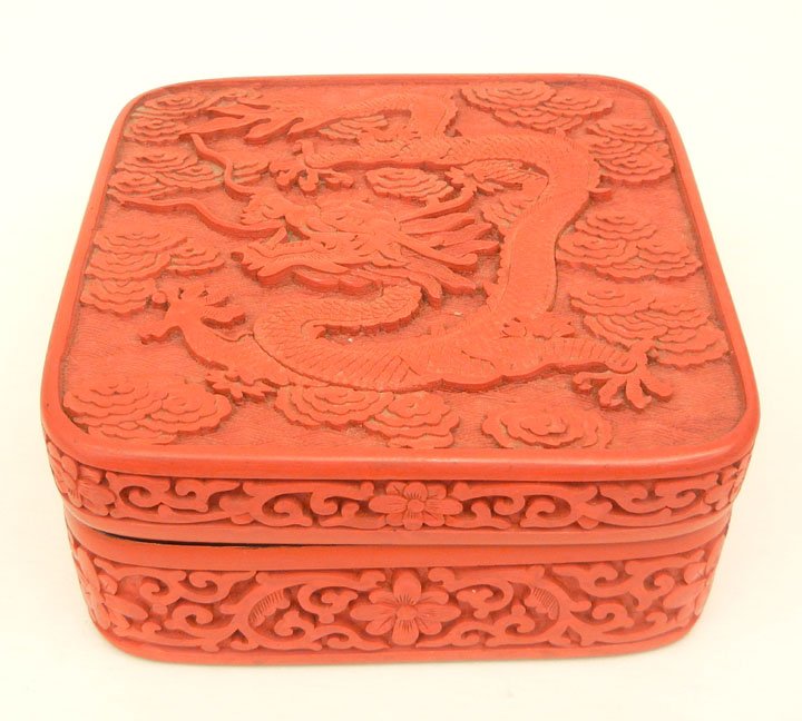 Chinese cinnabar laquered covered box, dragon decoratio: Chinese cinnabar laquered covered box, dragon decoration on top, floral relief on sides, square form, 2 1/2" high x 5 1/4" across