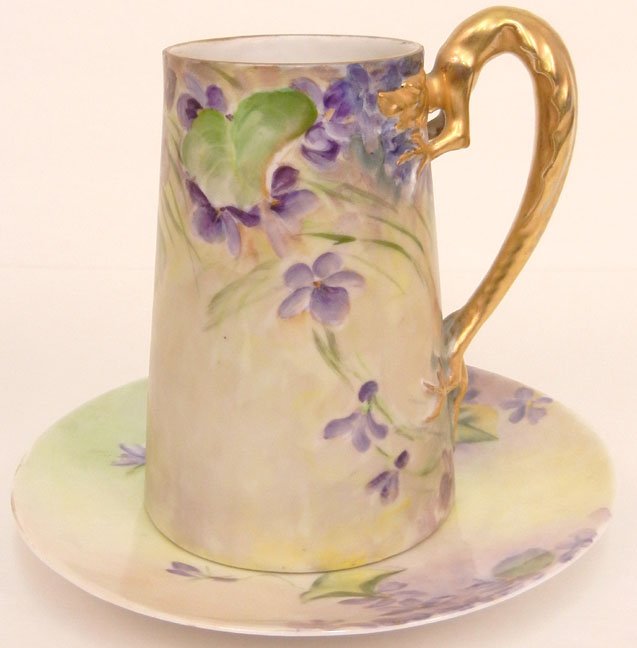Hand painted porcelain tankard and plate, both with vio: Hand painted porcelain tankard and plate, both with violet and leaf decoration, tankard with gilt dragon handle, signed Grace Tinker on bottom, plate signed C. Solomon on bottom, early 20th C., 6 1/2"