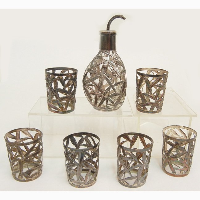 Sterling silver overlay butler's pinch bottle and set o: Sterling silver overlay butler's pinch bottle and set of six silver overlay shot glasses in all-over foliate design, all impressed Sterling 950 on bottom, bottle 4 1/4" high, shot glasses 1 3/4" high,