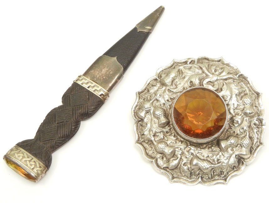 Scottish cloak pin and dirk, pin measures 3" in diamete: Scottish cloak pin and dirk, pin measures 3" in diameter, silver colored metal with thistle motif, large faceted cairngorm in center (possibly synthetic), dirk has bog oak handle with Celtic design an