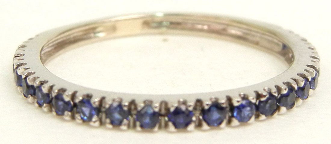 Gold and sapphire band, 14k white gold band set with tw: Gold and sapphire band, 14k white gold band set with twenty one round sapphires measuring approximately 1 point each, size 4 1/2, unmarked, tests 14k, weight 1.0 grams/0.7 dwt, mid 20th C.