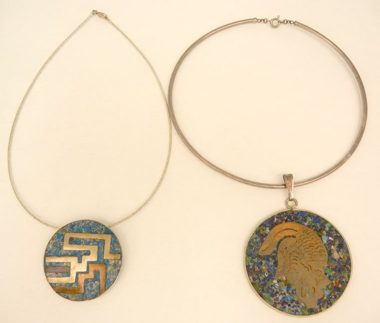 Two Mexican mixed metals pendants on neck wires, one pe: Two Mexican mixed metals pendants on neck wires, one pendant with sterling back, turquoise inlay on front with brass and copper geometric design, 1 3/4" diameter, marked Sterling Taxco Mexico G.P.R. E