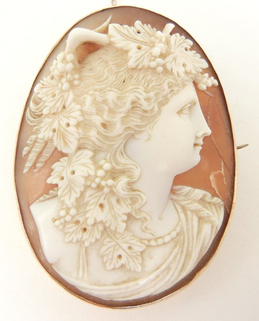 Victorian carved shell cameo of Juno Caprotina, Roman g: Victorian carved shell cameo of Juno Caprotina, Roman goddess of fertility, gold filled frame, cameo depicts woman with fig leaves and fruit in hair, 2" long x 1 1/2" wide, original C clasp, unmarked,