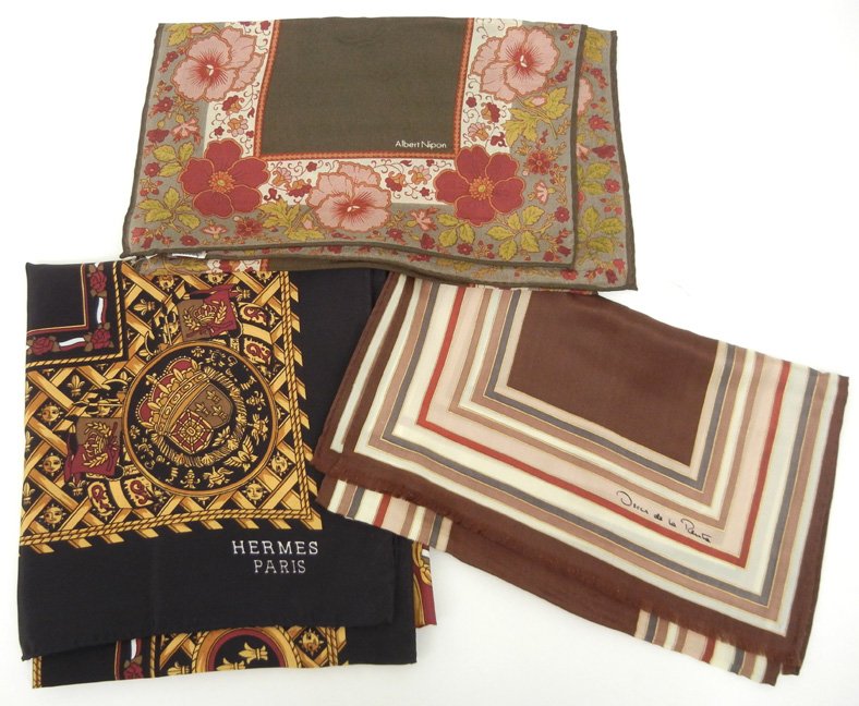 Three silk designer scarves including Hermes, Albert Ni: Three silk designer scarves including Hermes, Albert Nippon and Oscar de la Renta, Hermes scarf measures 34" x 34", black border with gold, white and dark red background, center medallion has crown an
