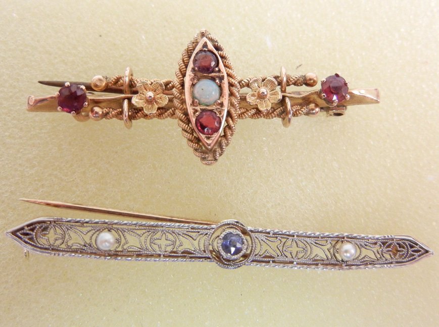 Two gold bar pins, one Edwardian 14k white and yellow g: Two gold bar pins, one Edwardian 14k white and yellow gold filigree, white gold top with one round sapphire measuring approximately 5 points and two small pearls, 1 7/8" long, marked 14k; and one Vict