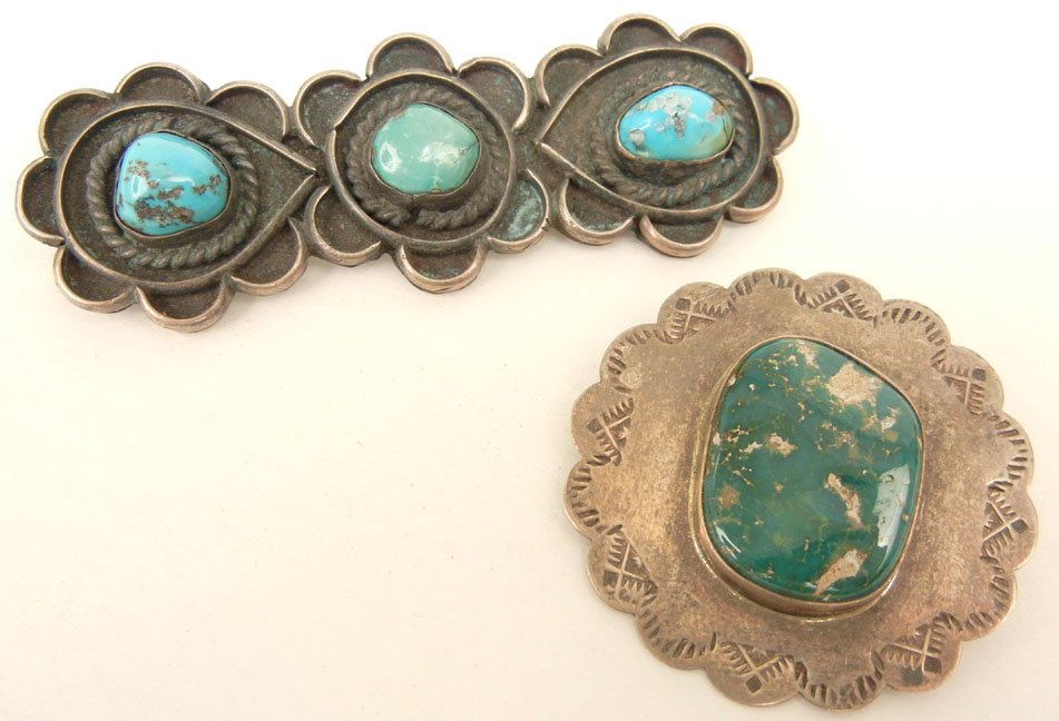Two Native American handmade sterling silver and turquo: Two Native American handmade sterling silver and turquoise pins, one with green turquoise stone measuring 22mm long x 18mm wide, pin is 1 5/8" in diameter, stamp work on border, signed Sara Platero, S