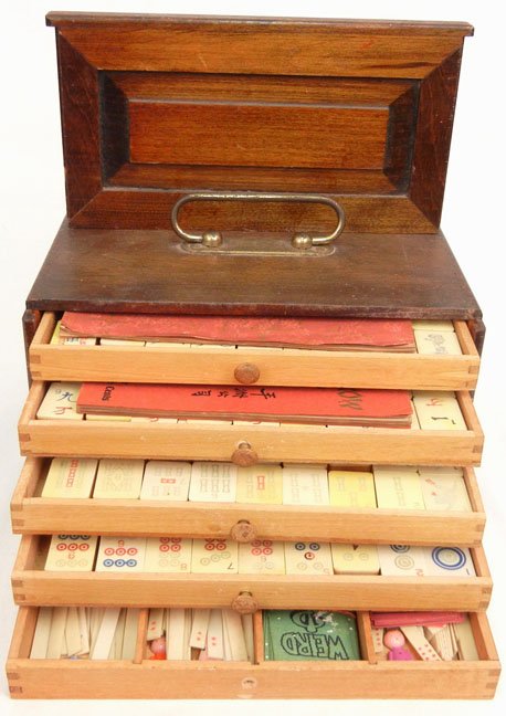 Pung Chow Company Majhong set in wooden box, the pieces: Pung Chow Company Majhong set in wooden box, the pieces are made of celluloid and wood, with two instruction books, one is Pung Chow in Ten Minutes, copyrighted 1923, the other is The Ancient Game of 