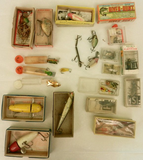 Grouping of fishing lures, approximately twenty-two, so: Grouping of fishing lures, approximately twenty-two, some in original boxes, including three Flatfish F5, one Flatfish, two Heddon Midget Digits, Heddon River Runt, Jitterbug, Pflueger's No. 3750 Yel-